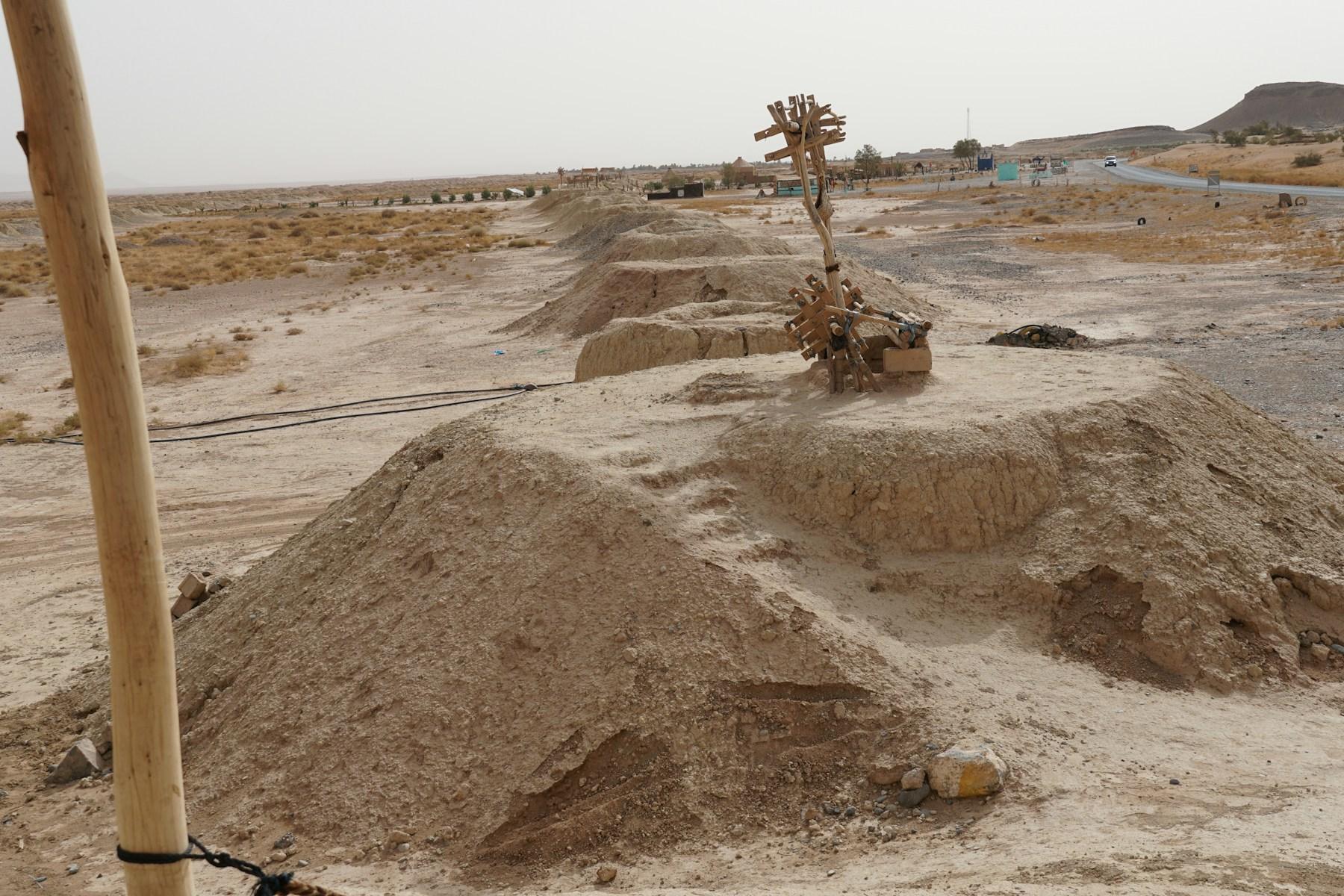 Ancient irrigation wells standing in a dry desert landscape
