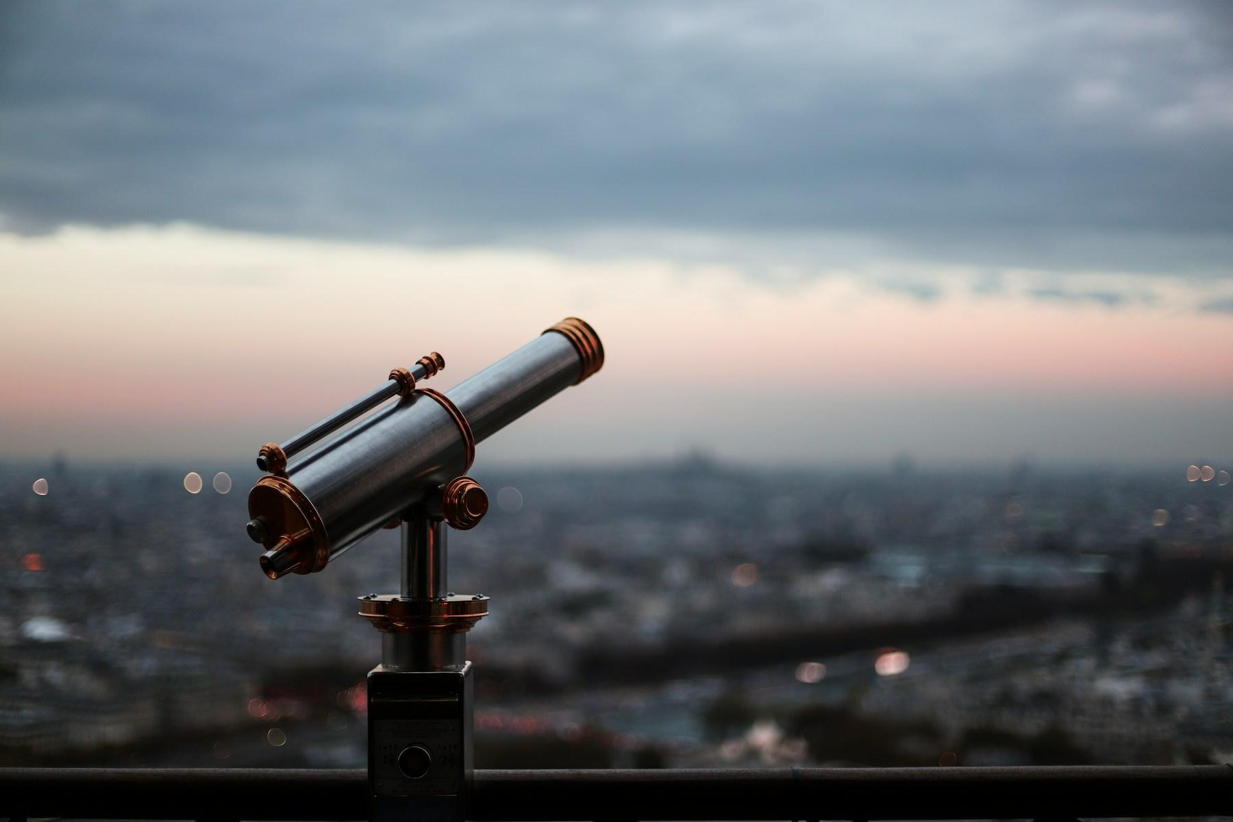 A large observatory telescope silhouetted against a pale sky