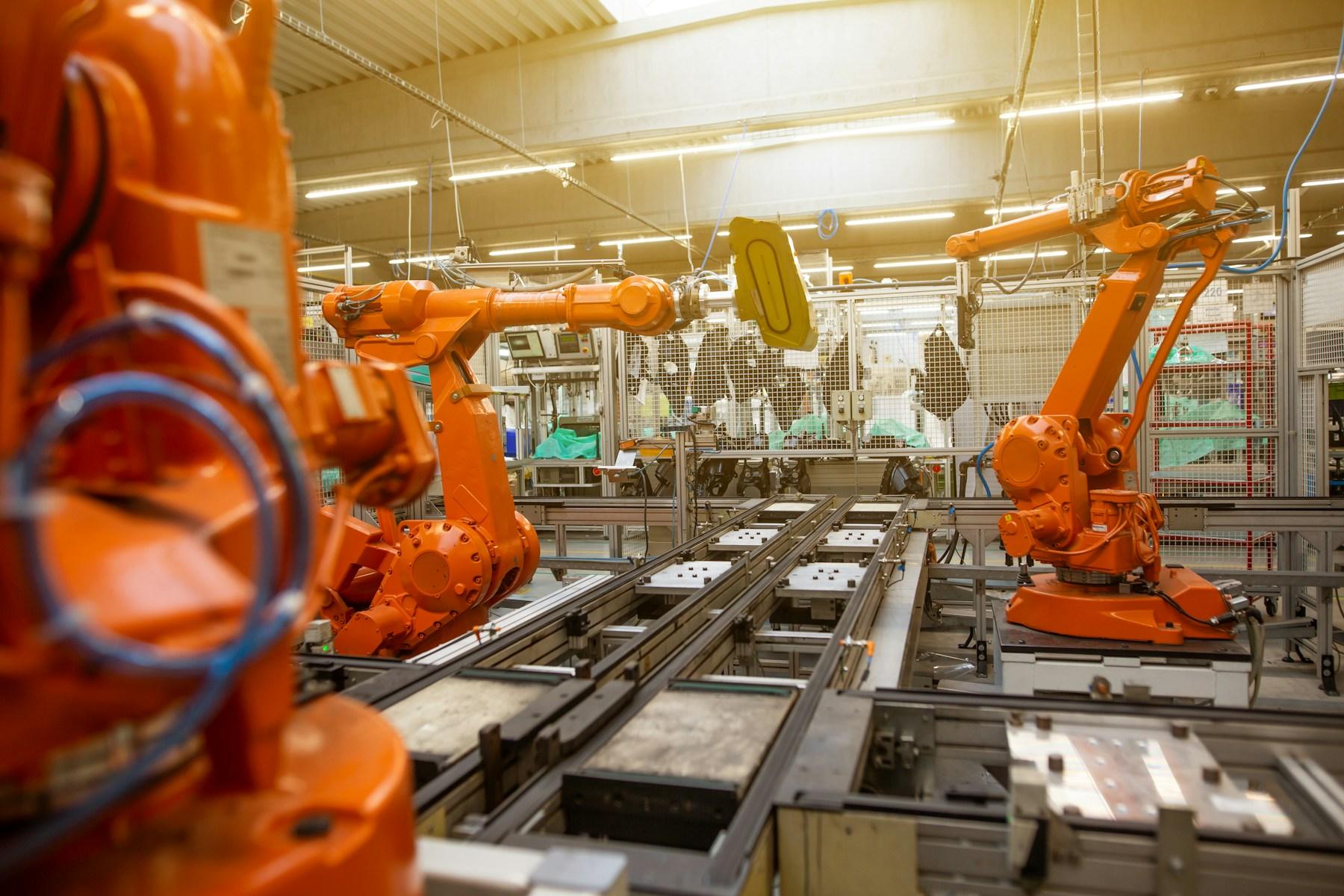 An industrial robotic arm working inside a modern facility